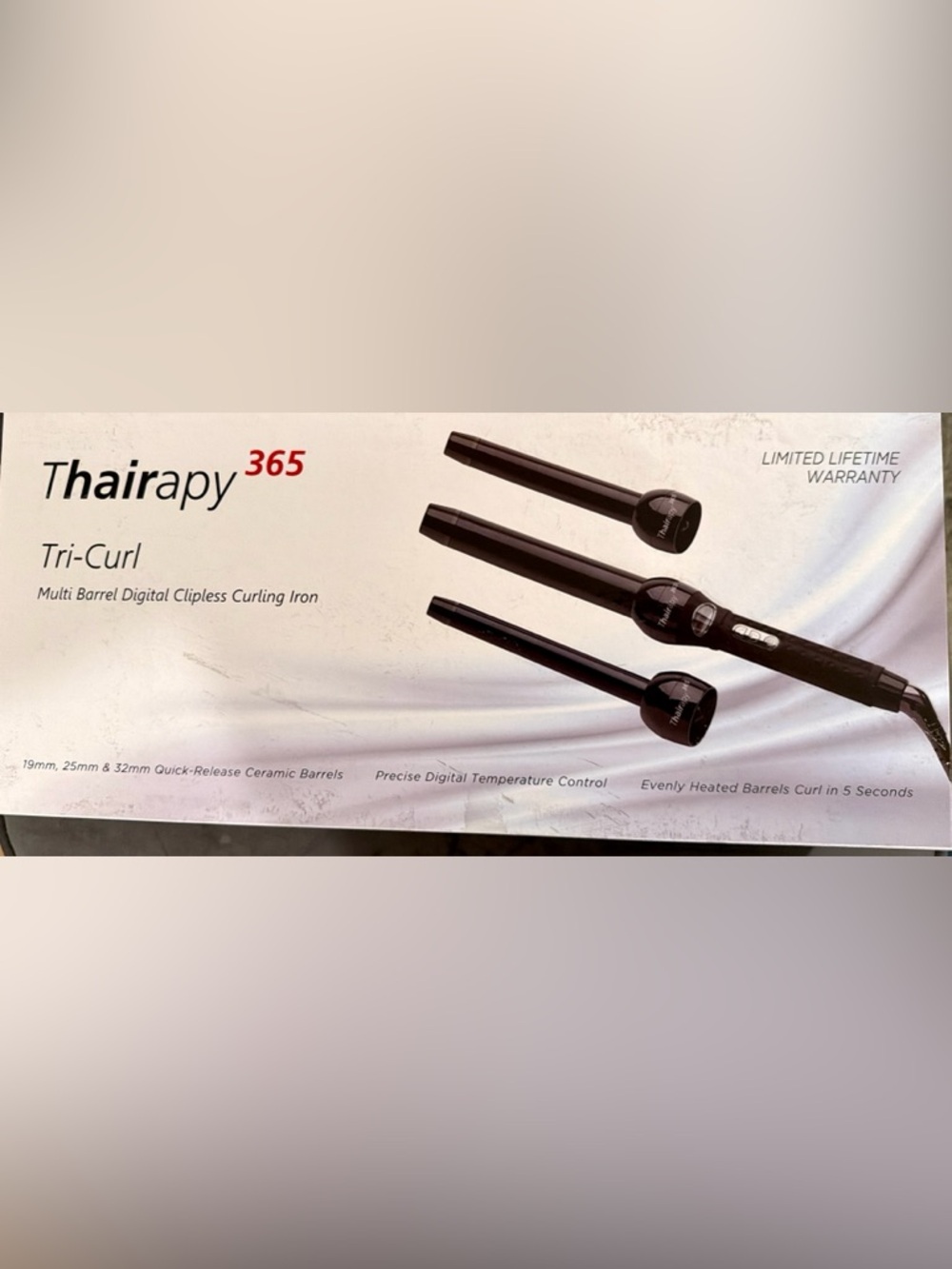 Thairapy 365 Tri-Curl multi barrel clipless curling iron.